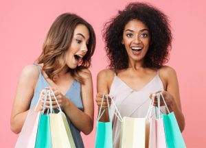 Two women happy with shopping bags